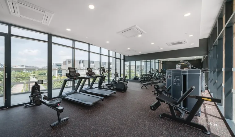 Gymnasium on the second storey of the Belgravia Ace clubhouse with floor-to-ceiling glazing